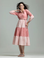 Woman wearing pink cotton Sunday dress with round v-cut neck and button down front