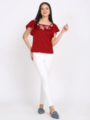 Maroon satin embroidered top styled with white pants, square neck, flared sleeves, curved hem, relaxed fit