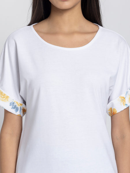 Detail view of white jersey knit t-shirt showing soft fabric texture and scoop neckline construction quality