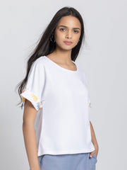 Right side profile of white scoop neck t-shirt showing curved hemline and soft jersey fabric drape